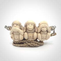This is a hand carved deer antler three wise monkeys pendant. It is made from deer antler, bone. This is a large sized necklace and is a very unique, one only, pendant that has an adjustable tan cord. Hand carved deer antler three wise monkeys necklace for men and women. Hear, Speak, See no evil monkey pendant.