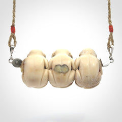 This is a hand carved deer antler three wise monkeys pendant. It is made from deer antler, bone. This is a large sized necklace and is a very unique, one only, pendant that has an adjustable tan cord. Hand carved deer antler three wise monkeys necklace for men and women. Hear, Speak, See no evil monkey pendant.