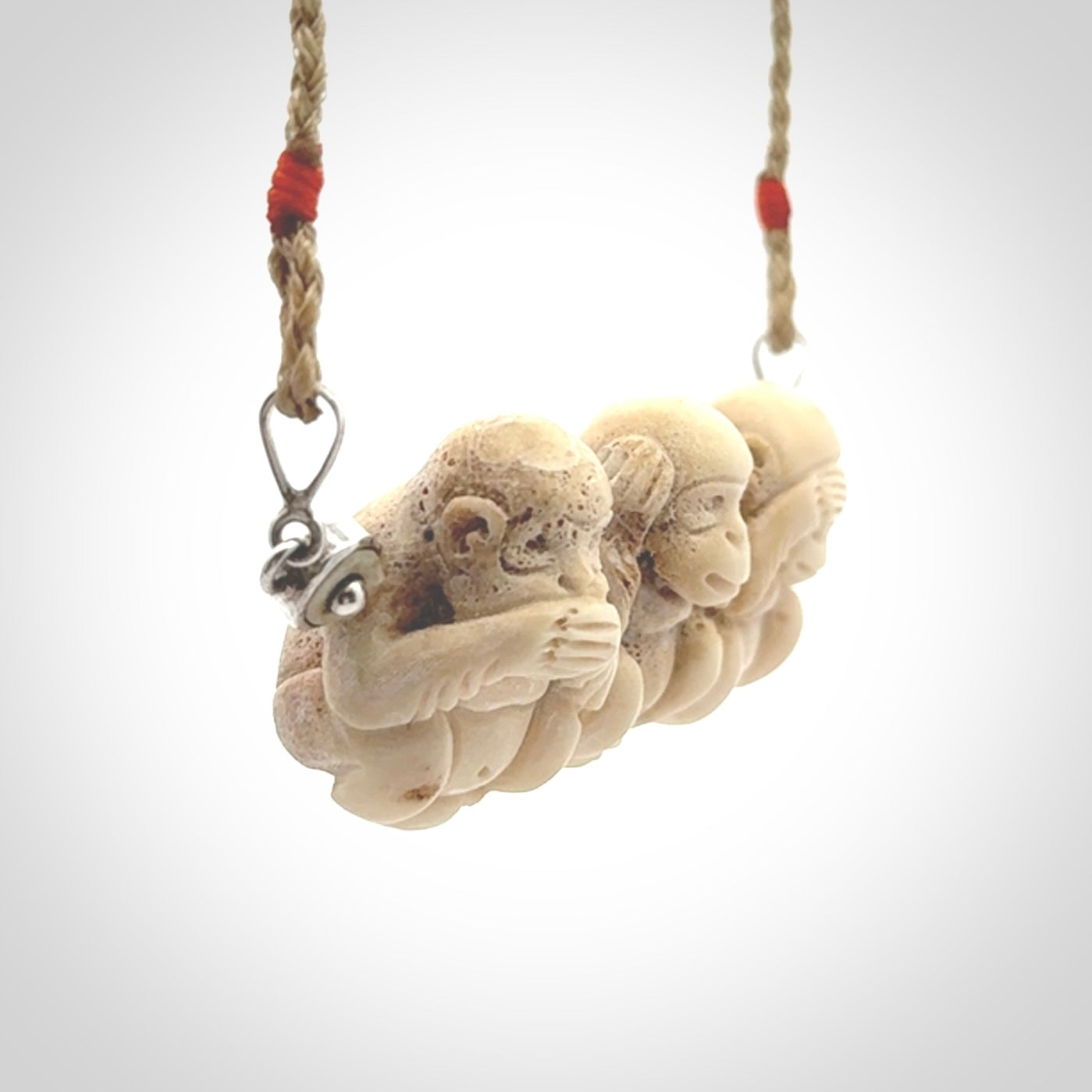 This is a hand carved deer antler three wise monkeys pendant. It is made from deer antler, bone. This is a large sized necklace and is a very unique, one only, pendant that has an adjustable tan cord. Hand carved deer antler three wise monkeys necklace for men and women. Hear, Speak, See no evil monkey pendant.
