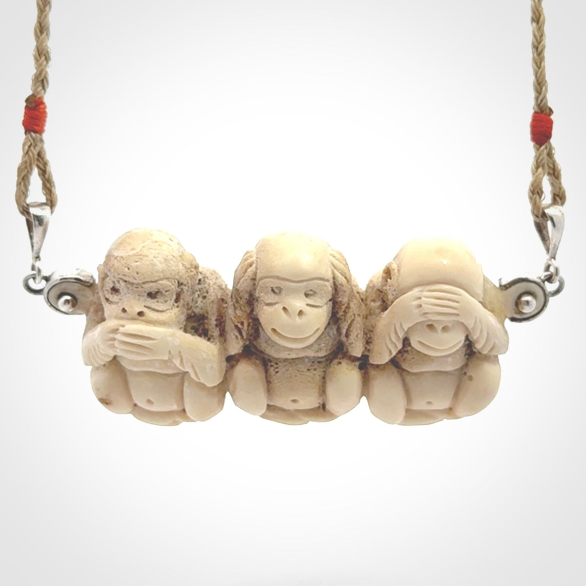 This is a hand carved deer antler three wise monkeys pendant. It is made from deer antler, bone. This is a large sized necklace and is a very unique, one only, pendant that has an adjustable tan cord. Hand carved deer antler three wise monkeys necklace for men and women. Hear, Speak, See no evil monkey pendant.