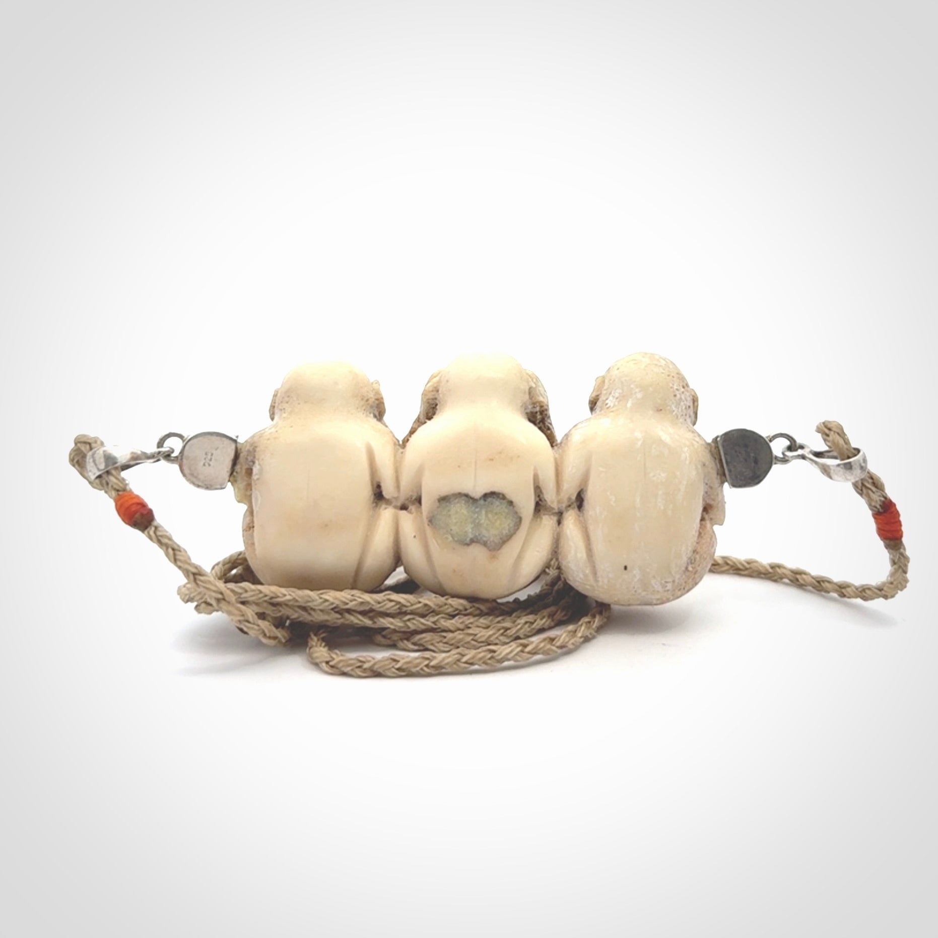 This is a hand carved deer antler three wise monkeys pendant. It is made from deer antler, bone. This is a large sized necklace and is a very unique, one only, pendant that has an adjustable tan cord. Hand carved deer antler three wise monkeys necklace for men and women. Hear, Speak, See no evil monkey pendant.