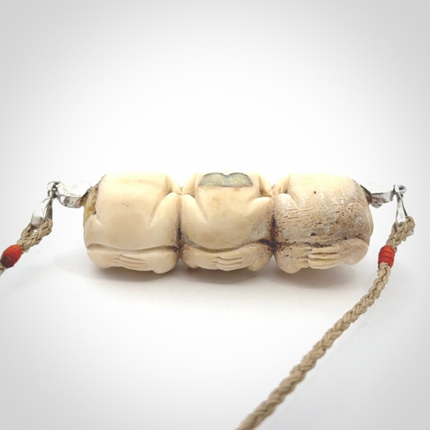 This is a hand carved deer antler three wise monkeys pendant. It is made from deer antler, bone. This is a large sized necklace and is a very unique, one only, pendant that has an adjustable tan cord. Hand carved deer antler three wise monkeys necklace for men and women. Hear, Speak, See no evil monkey pendant.