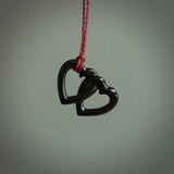 Hand carved double heart pendant made in black jade, green jade and jasper stone. Made by NZ Pacific. Carved from green jade, black jade and red jasper stone. Free delivery worldwide.