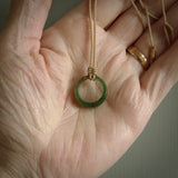 This piece is a oval round, ring pendant. It was carved for us by Ric Moor from a lovely light and milky green piece of New Zealand jade. It is suspended on a beige coloured braided cord that is length adjustable.