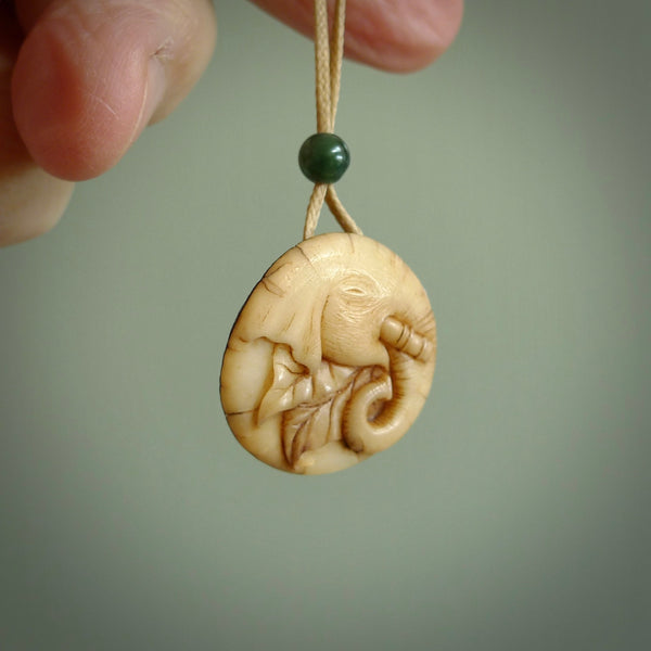 This is a hand carved elephant pendant. It is made from Tigara nut. This is a small sized necklace and is a very unique, one only, pendant that is a collectors piece. Hand carved by New Zealand artist, Sami.