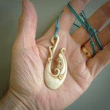 This pendant is a gorgeous and intricately carved mermaid hook pendant. Carved by renowned bone carver Yuri Terenyi for us. This is a masterpiece. It is a mermaid with her tail culminating into a hook. The craftsmanship displayed in this piece is extraordinary - a collectors item, or a piece to wear and love.