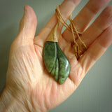 This is a unique flower pendant, hand carved from New Zealand Jade. The cord is a creme colour and is length adjustable. This is delivered to you with Express Courier. Hand carved Jade necklace replicating a flower blossom from Donna Summers.