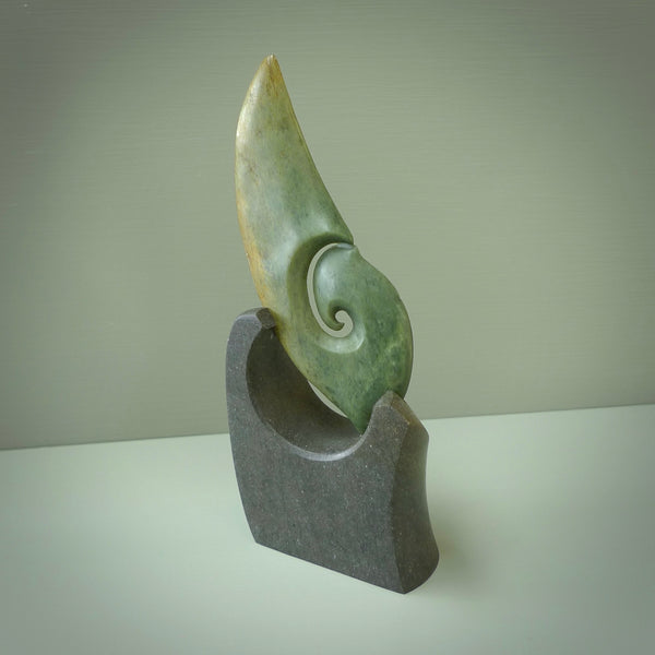 Hand carved New Zealand Flower Jade koru with Greywacke stand sculpture. Hand carved in New Zealand by Ric Moor. This is a one only sculpture and is a beautiful, large, display piece.