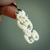 Hand carved bone Tiki pendant. Traditional art hand carved for NZ Pacific. Bone Tiki necklace with Paua Shell eyes.