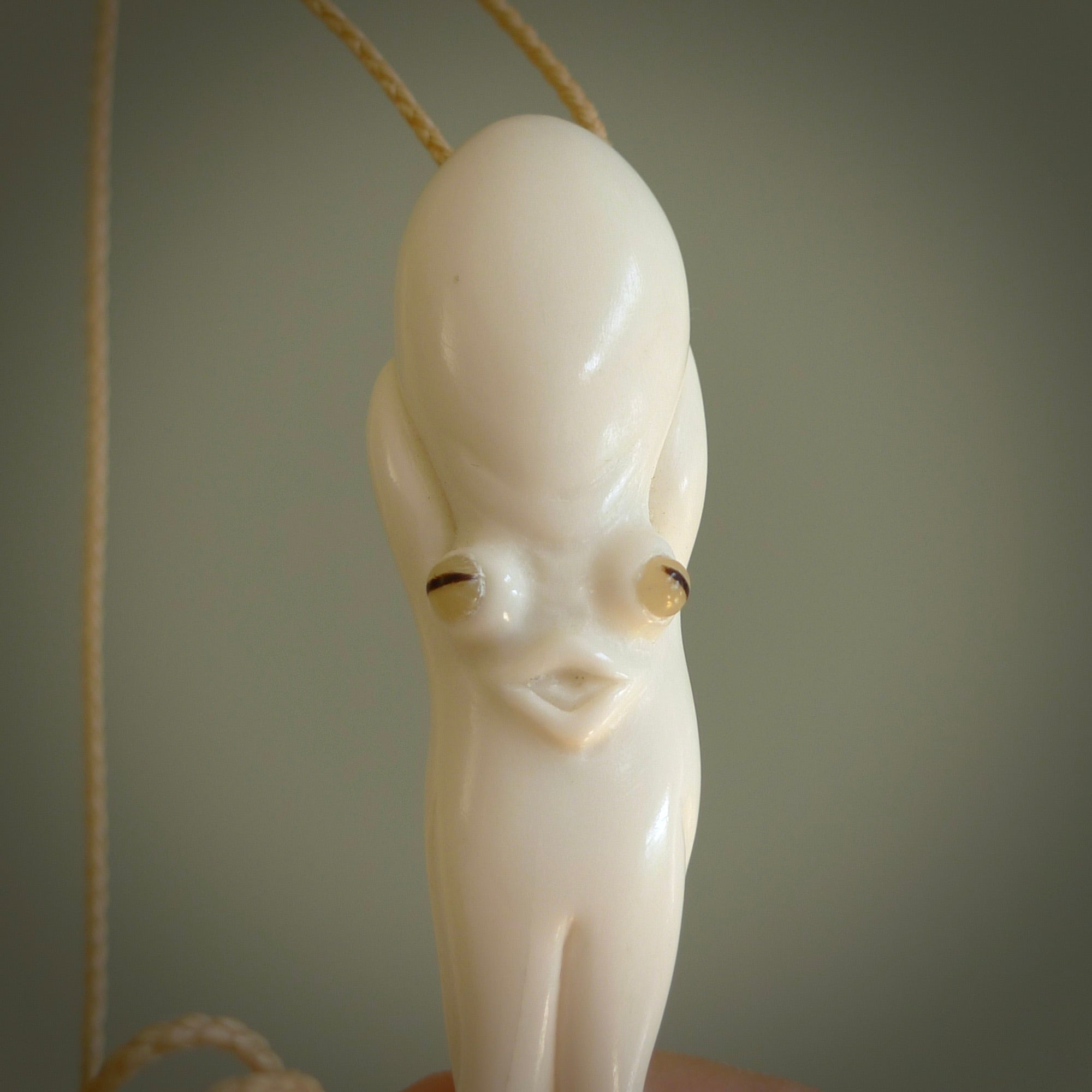 Hand carved octopus pendant in resting pose. This piece has been carved in incredible detail from bone. The artist is Fumio Noguchi, a renowned New Zealand bone carver who carves pieces for NZ Pacific. These unique bone pendants are for sale online at nzpacific.com One only collectors item for lovers of the ocean and octopus.