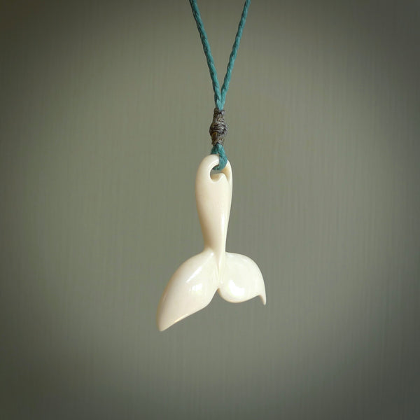 Hand carved bone whale tail pendant. Made by NZ Pacific. Bone whale tail necklace with adjustable cord.