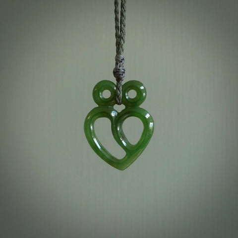 This is a handcarved love heart pendant made from a gorgeous and striking piece of British Columbia Jade stone. This is a superbly carved and very unique piece if custom jewellery. For sale online from NZ Pacific.