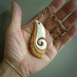 A hand carved bone contemporary, intricate pendant. The cord is a 4 strand, 3 plait in Ice White and Tan and is an adjustable length. A large sized hand made contemporary necklace by New Zealand artist Kerry Thompson. Kerry has stained parts of the bone which really add to the dimension of this pendant. One of work of art to wear.