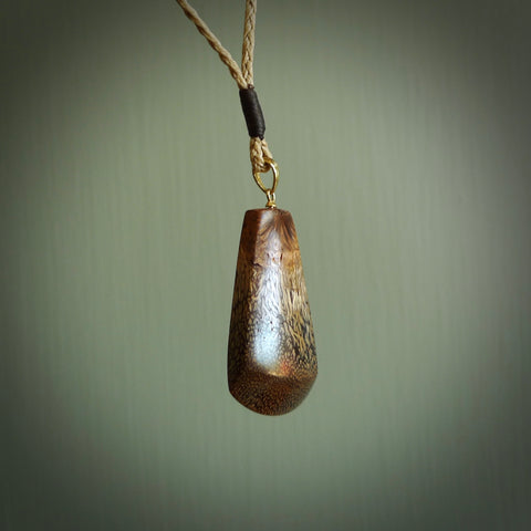 This is a medium sized, hand carved toki pendant. It is made from banksia wood. This is a medium sized Toki and very unique, one only, pendant that is a collectors piece. Hand carved by New Zealand artist, Sami.