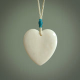 HAND CARVED HEART PENDANT. CARVED FROM BONE. PAUA HEART INSERT. HAND MADE BY NZ PACIFIC. HANDMADE JEWELLERY FOR SALE ONLINE.