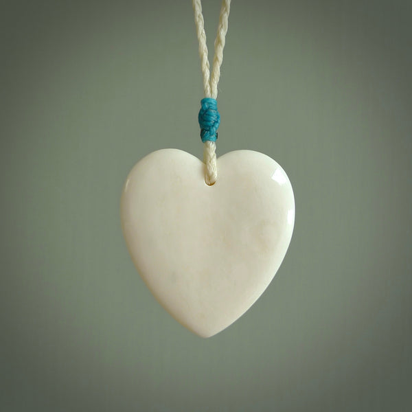 HAND CARVED HEART PENDANT. CARVED FROM BONE. PAUA HEART INSERT. HAND MADE BY NZ PACIFIC. HANDMADE JEWELLERY FOR SALE ONLINE.