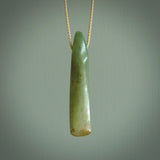 This is a lovely, large, New Zealand Flower Jade, pounamu drop pendant. Hand carved for us by Ric Moor. It is bound with an adjustable beige coloured cord which is length adjustable. Free worldwide shipping. The light reveals the internal structure and colour of the stone beautifully.