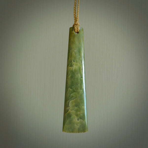 A hand carved large New Zealand Flower Jade drop, roimata, necklace. The cord is a tan colour and is adjustable. A large sized hand made drop necklace by New Zealand artist Kerry Thompson. One off work of art to wear.