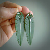 This picture shows British Columbian jade kaka feather earrings with sterling silver hooks. Hand made unique and contemporary feather earrings by Kerry Thompson. Hand carved here in New Zealand from British Columbian Jade. One pair only.