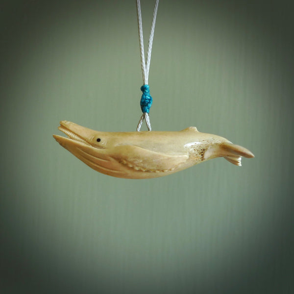 This little whale pendant is handcarved from deer antler. It is a wonderful, smaller piece that replicates a sperm whale breeching the waters surface. We provide this with a hand-plaited fine snowstorm grey necklace cord. Free shipping worldwide.