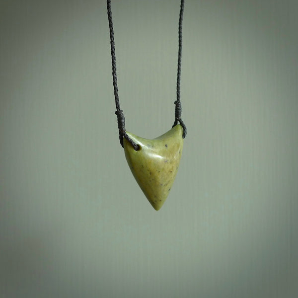 This is a lovely New Zealand Jade, pounamu drop pendant. Hand carved for us by Ric Moor. It is bound with an adjustable black coloured cord which is length adjustable. Free worldwide shipping.
