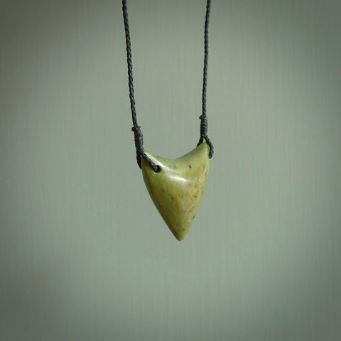 This is a lovely New Zealand Jade, pounamu drop pendant. Hand carved for us by Ric Moor. It is bound with an adjustable black coloured cord which is length adjustable. Free worldwide shipping.