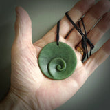 This pendant is a medium sized and disc with koru heart necklace carved from a deep green piece of New Zealand Jade. Kyohei Noguchi carved this piece for us so the workmanship is outstanding. Handmade in New Zealand, a beautiful piece of jade jewellery.