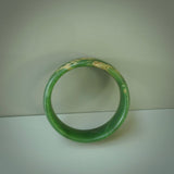 Hand carved jade bangle. Carved from green New Zealand jade. This is a solid jade bangle carved from a single piece of jade. It is polished to a sleek matte. the jade is otherwise untreated and completely natural.
