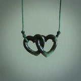 Hand carved double heart pendant made in black jade, green jade and jasper stone. Made by NZ Pacific. Carved from green jade, black jade and red jasper stone. Free delivery worldwide.