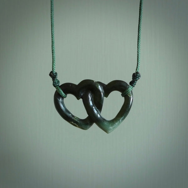 Hand carved double heart pendant made in black jade, green jade and jasper stone. Made by NZ Pacific. Carved from green jade, black jade and red jasper stone. Free delivery worldwide.