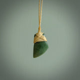 Hand carved jade toki by Ric Moor. Made in New Zealand by NZ Pacific. Hand carved Toki pendants crafted from beautiful New Zealand Pounamu, Jade. We deliver these with Express Courier, on adjustable cords.