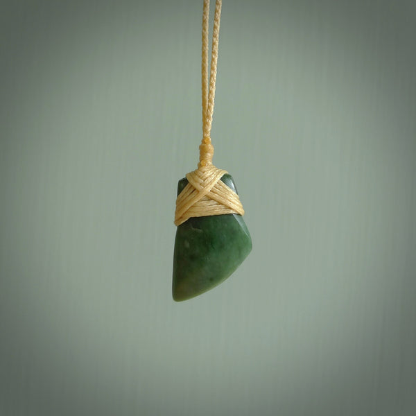 Hand carved jade toki by Ric Moor. Made in New Zealand by NZ Pacific. Hand carved Toki pendants crafted from beautiful New Zealand Pounamu, Jade. We deliver these with Express Courier, on adjustable cords.