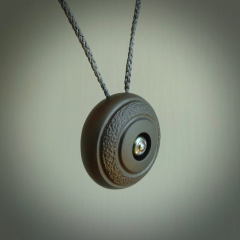 Argillite stone pendant with Black Pearl insert. Hand carved by Rhys Hall for NZ Pacific. Handmade contemporary jewellery for sale online.