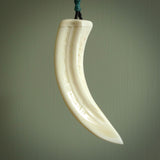 Hand carved engraved boars tusk pendant, carved by us. This particular piece is a contemporary design and is lovingly carved.