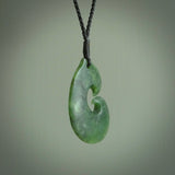 This photo shows a traditional hook pendant. It a a lovely deep green jade. The cord is a four plait black and is adjustable in length. One only, contemporary matau necklace from Jade, by Ric Moor.