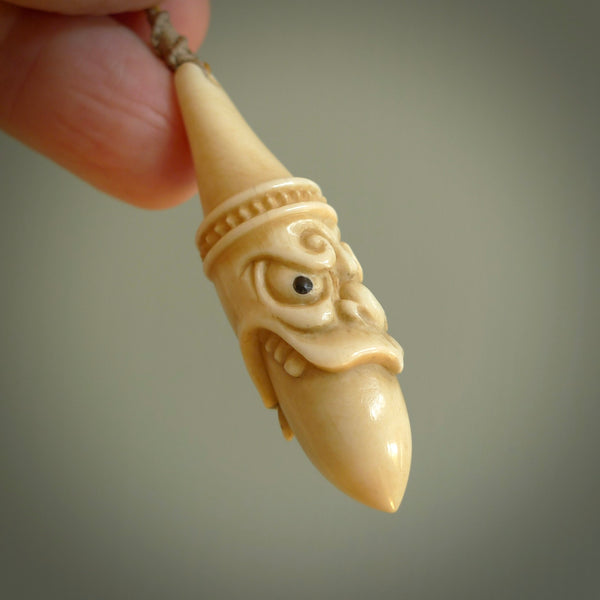 Hand carved incredible stained bone gargoyle face carving. A stunning work of art. This pendant was hand carved in bone with buffalo horn inlay for the eyes by Yuri Terenyi. A one off collectors item that has been hand crafted to be worn or displayed.
