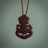 This is a medium sized tiki - carved from gorgeous red Jasper Stone. The craftsmanship is superb, this piece is as well carved as any we have seen. The cord is an adjustable plaited cord in Wapiti Brown and Burgundy.