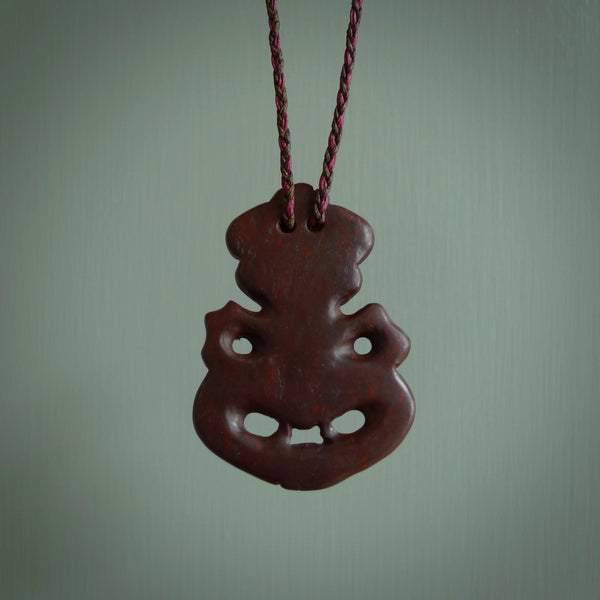 This is a medium sized tiki - carved from gorgeous red Jasper Stone. The craftsmanship is superb, this piece is as well carved as any we have seen. The cord is an adjustable plaited cord in Wapiti Brown and Burgundy.