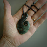 This matau, is carved from a very striking New Zealand Marsden jade. It is both intricate and simple in design - it has hidden folds and smooth curves. A piece to be worn or displayed - the carving and the jade are both magnificent. Hand made by New Zealand Master Carver Donna Summers. Unisex pendants online for sale.