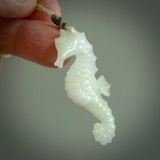 A hand carved Jadeite seahorse pendant. We have carved this from beautiful jadeite and we bind them with our hand-plaited cords. The cords are a waxed polyester so they are durable and strong. We ship these worldwide with express courier anywhere in the world.