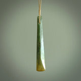 This is a lovely, large, New Zealand Flower Jade, pounamu drop pendant. Hand carved for us by Ric Moor. It is bound with an adjustable beige coloured cord which is length adjustable. Free worldwide shipping. The light reveals the internal structure and colour of the stone beautifully.