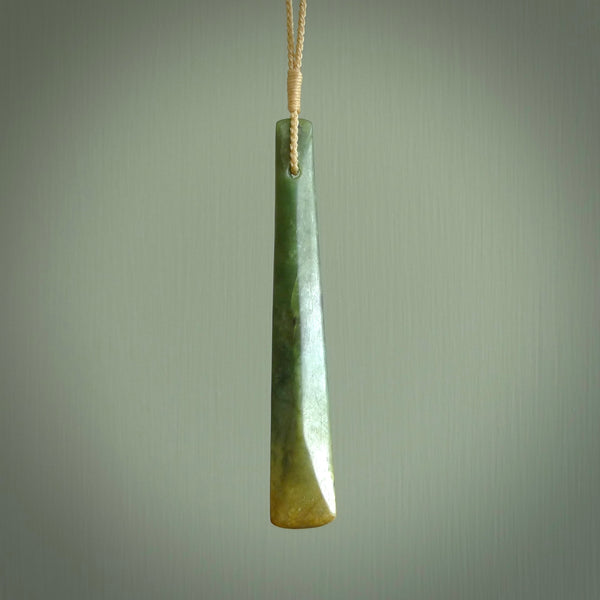 This is a lovely, large, New Zealand Flower Jade, pounamu drop pendant. Hand carved for us by Ric Moor. It is bound with an adjustable beige coloured cord which is length adjustable. Free worldwide shipping. The light reveals the internal structure and colour of the stone beautifully.