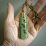 Hand made New Zealand jade drop with koru pendant. Hand carved in New Zealand by Kerry Thompson. Hand made jewellery. Unique large Jade drop with fixed length tan coloured cord. Free shipping worldwide.