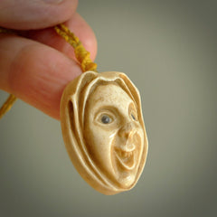 Hand carved incredible stained bone gargoyle face carving. A stunning work of art. This pendant was hand carved in bone with buffalo horn inlay for the eyes by Yuri Terenyi. A one off collectors item that has been hand crafted to be worn or displayed.