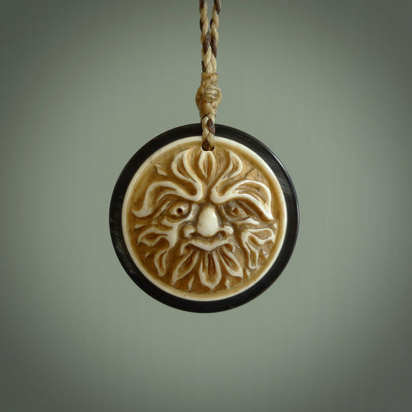 Hand carved natural bone with buffalo horn contemporary disc pendant with creative and unique carvings on the front face of each individual piece. Delivered with an adjustable cord.