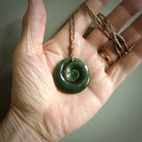 This pendant is a medium sized and gorgeous koru necklace carved from a deep green piece of New Zealand  Jade. Ross Crump carved this piece for us so the workmanship is outstanding. Handmade in New Zealand, a beautiful piece of jade jewellery.