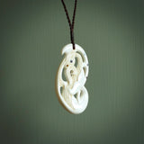 Bone carving of a taniwha. A three dimensional pendant carved in bone by Andrew Doughty. One only taniwha carving for men and women. Provided with an adjustable cord.