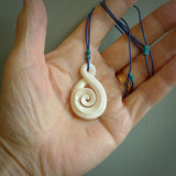 Hand carved bone twist with koru pendant. Real natural bone. These are suspended on a length adjustable plaited cord.