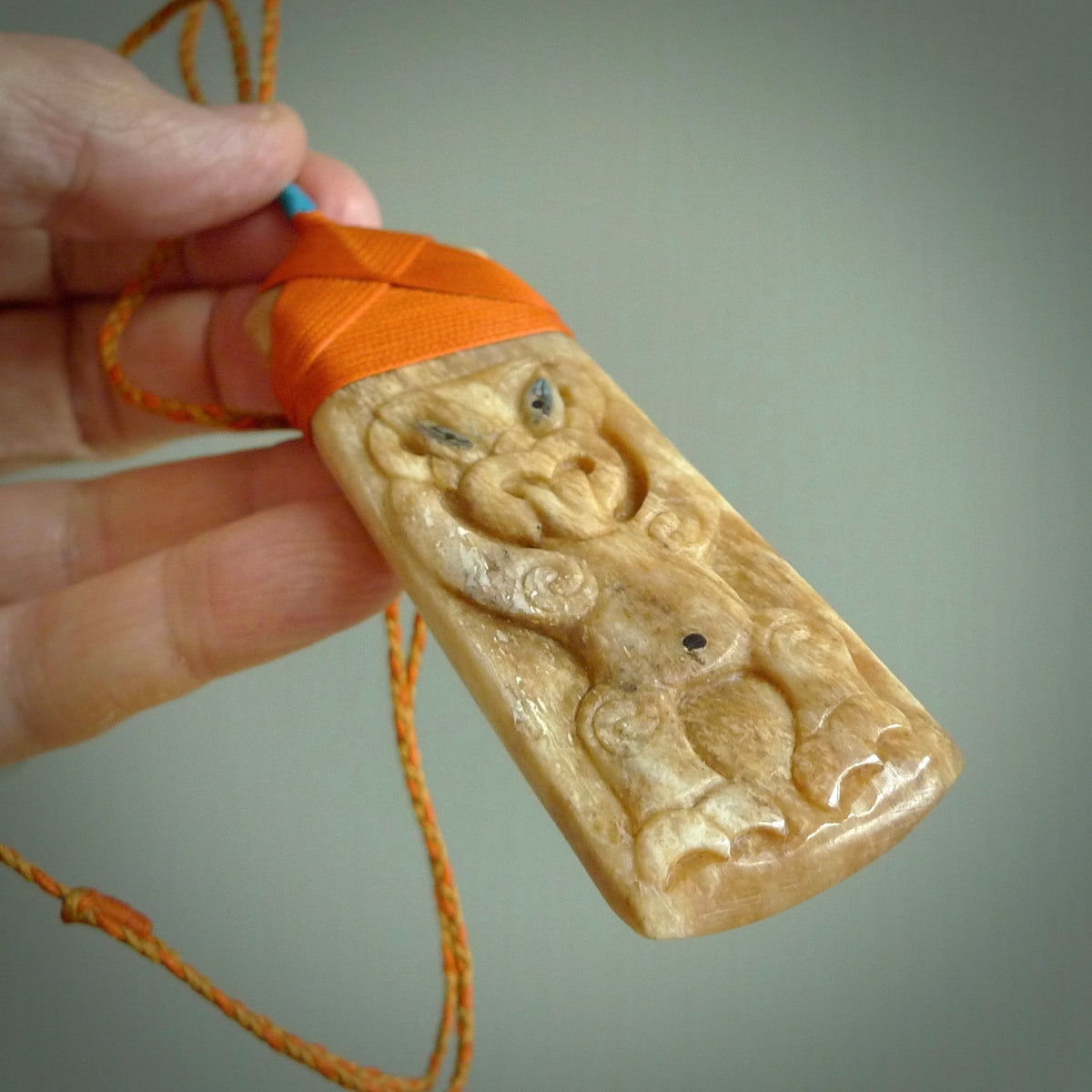 HAND CARVED BONE TOKI WITH TIKI PENDANT. BONE TOKI WITH TIKI PENDANT