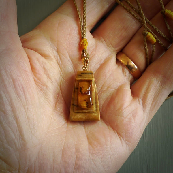 This is a hand carved woolly mammoth tusk with amber contemporary pendant. It is made from woolly mammoth tusk with amber. This is a small sized necklace and is a very unique, one only, pendant that is a collectors piece. Hand carved by New Zealand artist, Sami.
